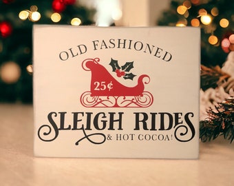 Add a Touch of Nostalgia to Your Holiday Decor with our 8" x 10" Ivory Wood Canvas Sign Featuring Old Fashioned Sleigh Rides in Black Vinyl
