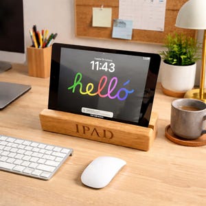 May include: A white ceramic mug with a black handle and the text "But First, Coffee" in a bold, black font. The mug is set against a blurred background, suggesting a cosy setting.