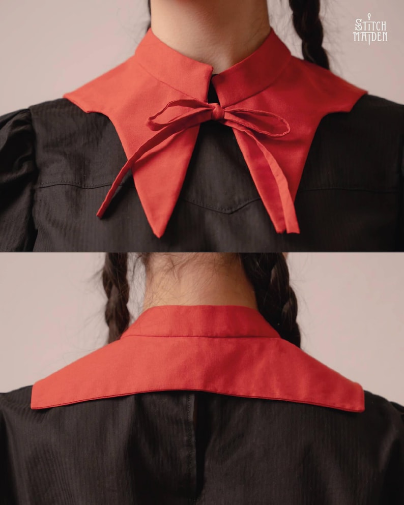 May include: A red detachable collar with a bow detail, worn over a black garment. The collar has a pointed shape and a contrasting colour against the dark fabric. The image shows the front and back of the collar.