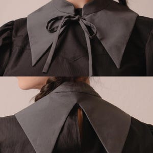 May include: A grey detachable collar with a pointed design and a matching tie. The collar is worn over a dark grey shirt. The image shows the front and back of the collar. The text "Stitch Maiden" is visible in the upper right corner.