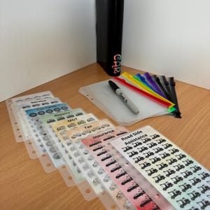 May include: A set of clear plastic pockets with colourful tabs and labels for organising car documents. The labels include "Service", "Car Tyres", "Repairs", "MOT", "Tax", "Insurance", and "Road Side Assistance".