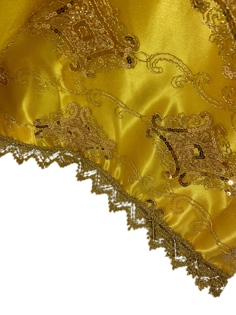 May include: Gold fabric with a gold lace trim and a pattern of sequins and embroidery.