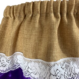 May include: A brown burlap valance with a white lace trim and a purple satin backing.
