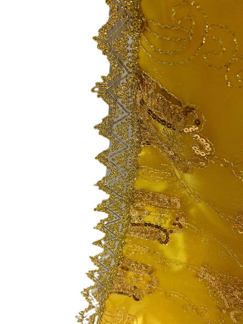 May include: A yellow fabric with gold embroidery and sequins along the edge.