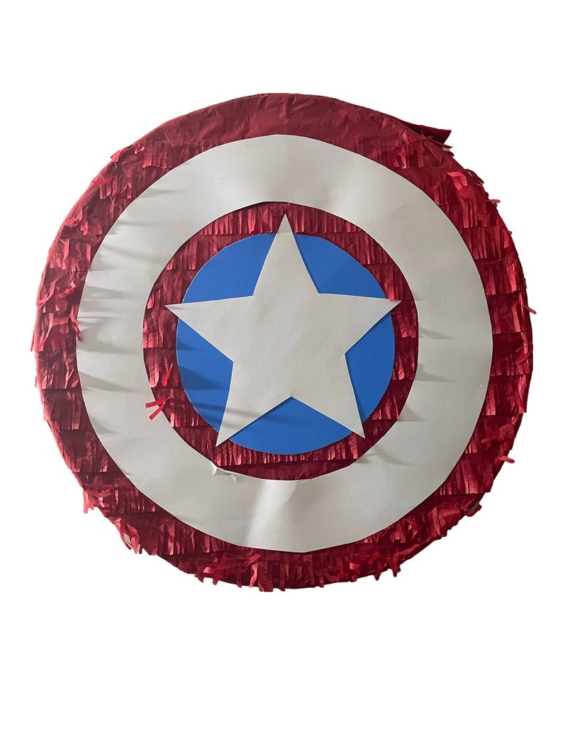 May include: A red, white, and blue Captain America shield pi&ntilde;ata. The shield has a white star on a blue background.