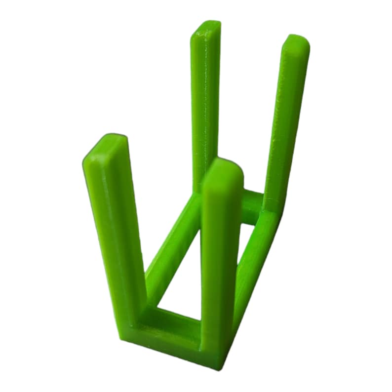May include: A bright green, 3D-printed stand with a rectangular base and four vertical supports. The supports are evenly spaced and form a square shape, with a slot at the top for holding an item. The stand is made of plastic.