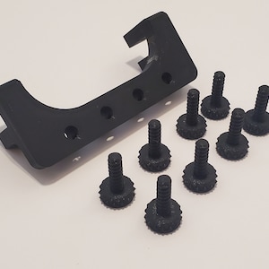 May include: A black plastic 3D printed part with eight black plastic screws. The part has a curved shape and several holes.