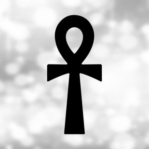May include: A black ankh symbol, an ancient Egyptian hieroglyph, against a blurred white background.