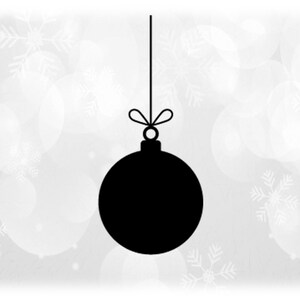 May include: A black Christmas ornament silhouette hanging from a string with a bow. The background is a soft, blurred pattern of white circles and snowflakes, creating a festive holiday atmosphere.