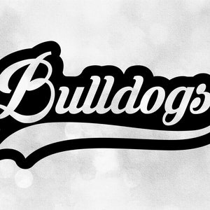 May include: A black and white graphic with the word "Bulldogs" in a stylized script font. The word is outlined in black, with a black banner shape beneath it. The background is a soft, blurred, light gray.