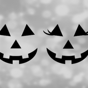 May include: Two black jack-o'-lantern faces with a simple design. One face has eyelashes and the other does not.