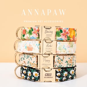 May include: Stack of personalized pet collars with floral patterns and gold-colored hardware. Each collar features a name and contact information. The collars are in various colors, including white, black, and beige.
