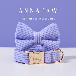 May include: A lavender corduroy dog collar with a gold buckle and a matching bow tie. The collar is personalized with the name "Mickey".