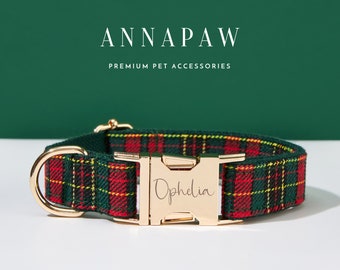 May include: A red and green plaid dog collar with a gold buckle. The buckle is engraved with the name "Ophelia".