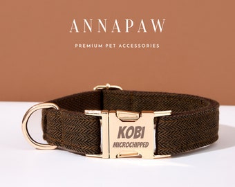 May include: A brown and black herringbone patterned dog collar with a gold metal buckle. The buckle has the name "Kobi" and the text "Microchipped" engraved on it.