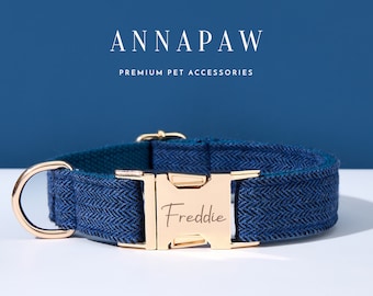 May include: A blue and black herringbone patterned dog collar with a gold metal buckle. The buckle is engraved with the name "Freddie".