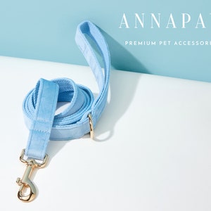 May include: A light blue velvet dog lead with a gold metal clasp and a gold ring. ANNAPAW PREMIUM PET ACCESSORIES.