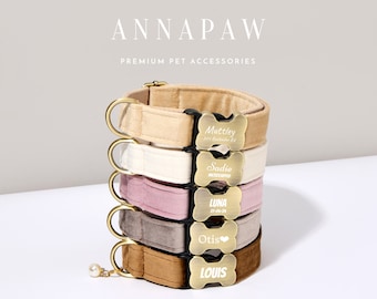 May include: A stack of five velvet dog collars in different colors, each with a gold bone-shaped tag engraved with a dog's name. The collars are beige, white, pink, gray, and brown. The tags read "Muttley 10-2-2018", "Sadie", "Luna 21-06-20", "Otis", and "Louis".
