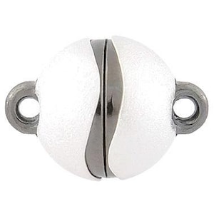 May include: White magnetic clasp with a silver-toned metal frame. The clasp is round and has a smooth, pearlescent finish.