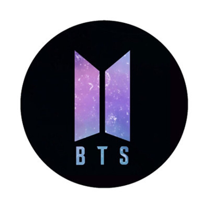 May include: A black circular graphic featuring the letters "BTS" in a light blue font. The letters are below a stylized logo with two vertical, open-ended, purple and blue shapes, resembling open doors or pillars, against a galaxy background.