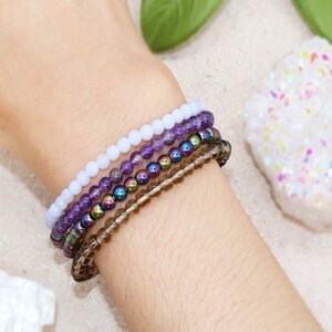 Anti Anxiety Crystal Bracelets 4mm round beads of Amethyst, Blue Lace Agate, Smoky Quartz, Rainbow Hematite on Women's Wrist. Dainty stackable crystal bracelet design with intention of relieving stress and worry.