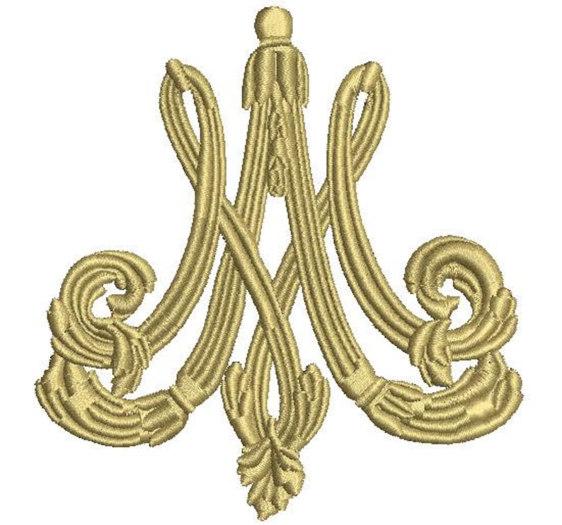 May include: A gold embroidered monogram of the letters "M" and "A" intertwined with ornate floral details. The monogram is a traditional symbol of the Virgin Mary.