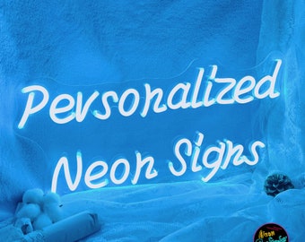 May include: Personalized Neon Signs in white lettering on a blue background. The sign is lit up and glowing. The text is in a cursive font.