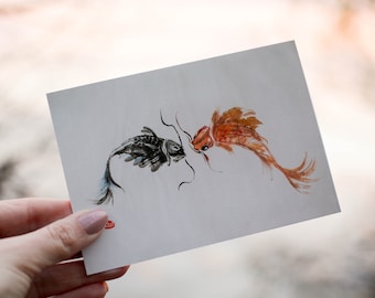 May include: A watercolor painting of two fish, one black and one orange, facing each other. The fish are painted in a simple, elegant style.