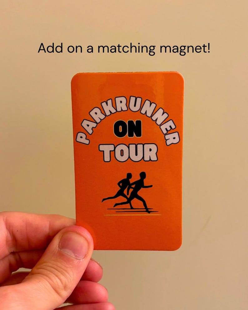 May include: A rectangular orange card featuring the black text PARKRUNNER ON TOUR and a black silhouette graphic of two people running. Above the card, the text reads Add on a matching magnet! The card has rounded corners and a smooth finish.