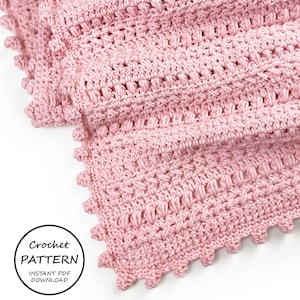 May include: A close-up of a soft, pink crocheted blanket. The blanket features a textured stitch pattern and a scalloped edge. The words "Crochet Pattern Instant PDF Download" are in a circle in the lower left corner.