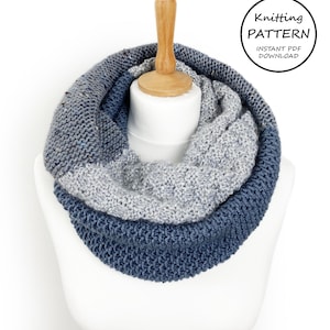 May include: A knitted cowl in shades of blue and gray. The cowl is displayed on a wooden mannequin. The text "Knitting Pattern Instant PDF Download" is visible in the upper right corner of the image.