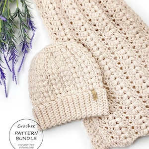 May include: A cream-coloured crochet hat and scarf set. The hat has a folded brim and a small tag. The scarf is rectangular with a textured pattern. The set is displayed on a white surface with purple flowers. The image includes the text "Crochet Pattern Bundle".