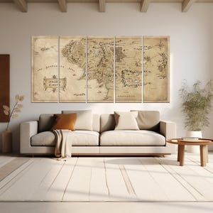 May include: A vintage-style map of Middle-earth, the fictional world from The Lord of the Rings, printed on five canvas panels. The map is in shades of brown and beige, with black text and lines. The map is hung on a wall in a living room setting, above a white couch and a wooden coffee table.