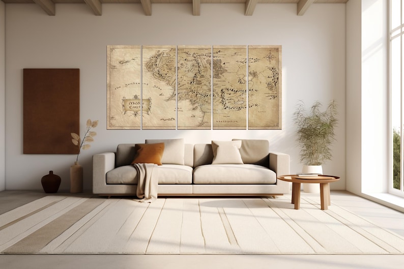 May include: A vintage-style map of Middle-earth, the fictional world from The Lord of the Rings, printed on five canvas panels. The map is in shades of brown and beige, with black text and lines. The map is hung on a wall in a living room setting, above a white couch and a wooden coffee table.