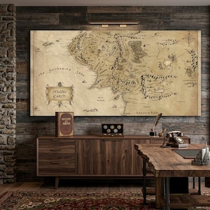 May include: A large, rectangular wall art print featuring a detailed, vintage-style map of Middle-earth with parchment-coloured background, black ink topography, and the text Middle-earth prominently displayed in a decorative frame on the left side.
