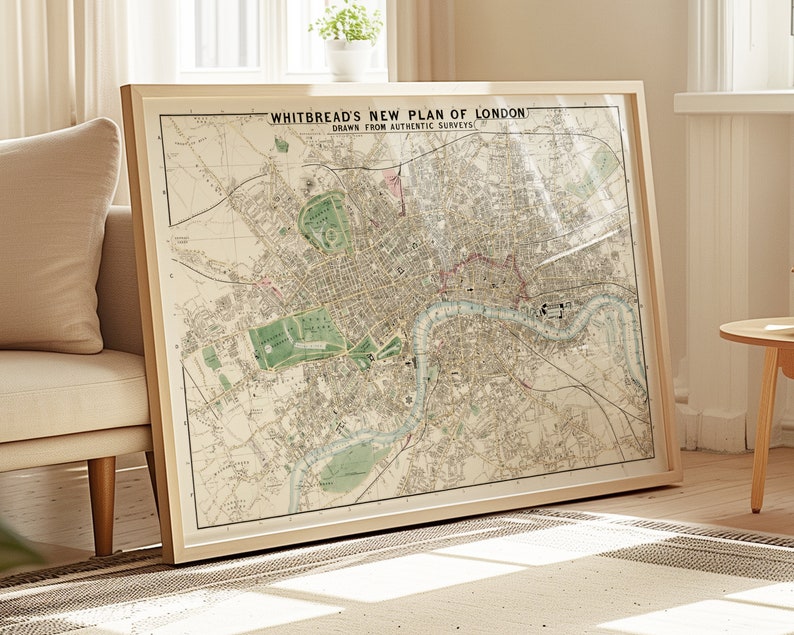 May include: A framed vintage map of London, titled "Whitbread's New Plan of London, Drawn from Authentic Surveys". The map is printed on cream-colored paper with brown, green, and red details. The map shows the River Thames winding through the city.