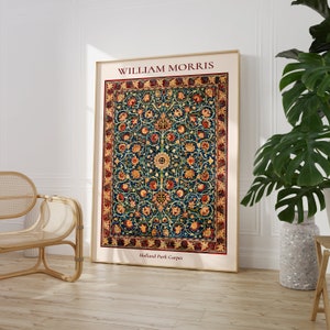 May include: A framed print of a vintage rug design by William Morris, titled "Holland Park Carpet". The rug features a repeating pattern of stylized flowers and leaves in shades of red, yellow, blue, and green on a dark blue background.