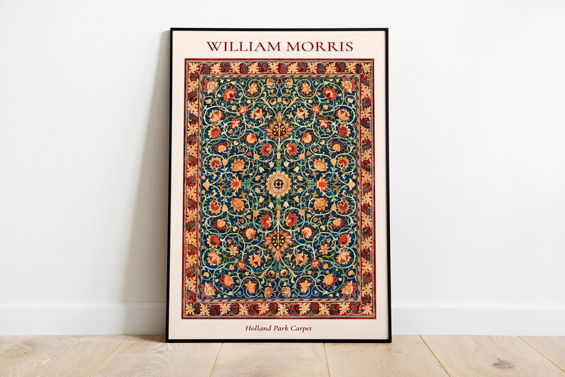 May include: A framed print of a vintage William Morris Holland Park Carpet design. The carpet features a repeating pattern of stylized flowers and leaves in shades of red, orange, yellow, green, and blue on a dark blue background.