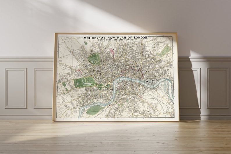 May include: A vintage map of London, England, titled "Whitbread's New Plan of London, Drawn from Authentic Surveys". The map is framed in a light wood frame and is displayed on a light wood floor.