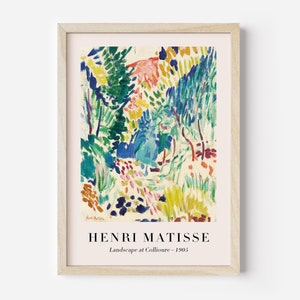 May include: A framed print of a painting by Henri Matisse titled "Landscape at Collioure - 1905". The painting features a colorful landscape with trees, foliage, and a path in shades of green, blue, yellow, red, and pink.