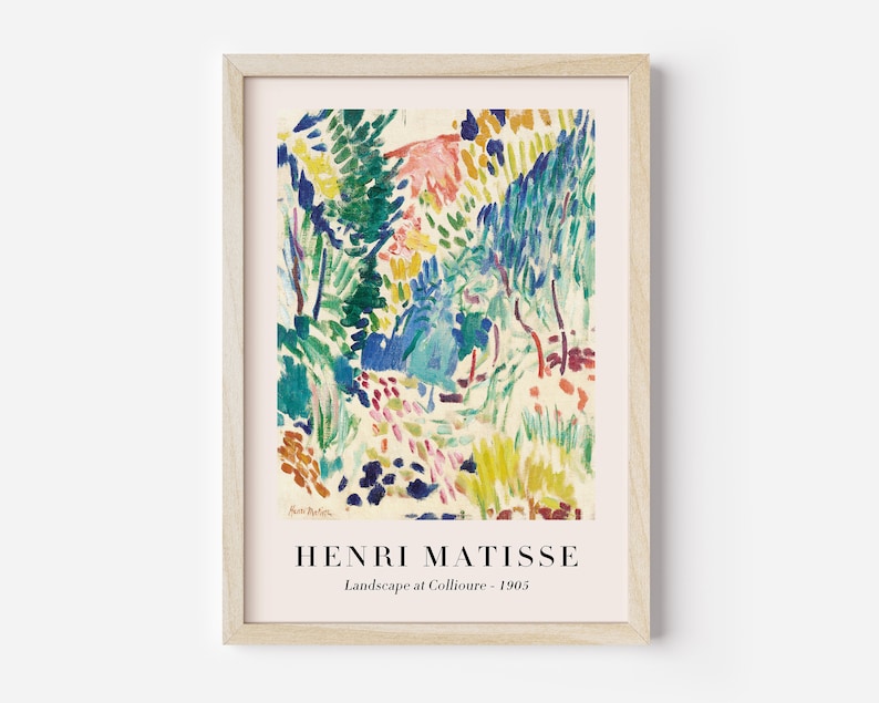 May include: A framed print of a painting by Henri Matisse titled "Landscape at Collioure - 1905". The painting features a colorful landscape with trees, foliage, and a path in shades of green, blue, yellow, red, and pink.