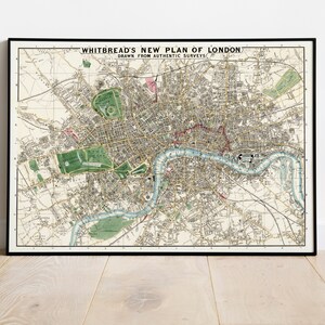 May include: A vintage map of London, England, titled "Whitbread's New Plan of London, Drawn from Authentic Surveys". The map is printed in black and white with green and blue accents. The map shows the River Thames winding through the city.