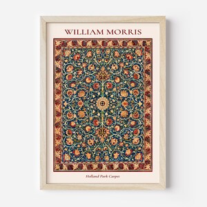 May include: A framed print of a vintage rug design by William Morris, featuring a blue background with intricate floral patterns in shades of red, yellow, and green. The title "Holland Park Carpet" is printed below the design.