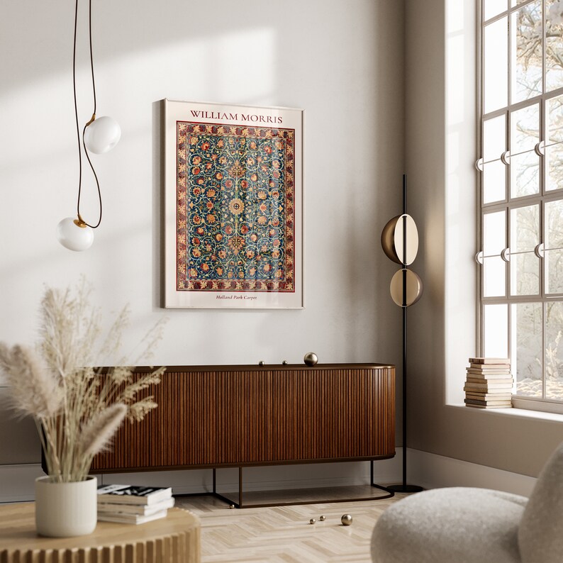 May include: A poster featuring a vintage design of a rug with a floral pattern. The poster is titled "William Morris" and has the text "Holland Park Carpet" at the bottom. The poster is hanging on a white wall above a wooden cabinet.