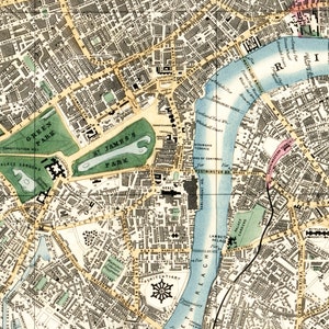May include: An antique map of London, England, showing the River Thames, St. James's Park, Green Park, and Westminster Bridge. The map is printed in black, brown, and green ink on a white background.