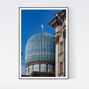 May include: A blue and white tiled dome of a mosque with a crescent moon on top against a bright blue sky.