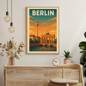 May include: A vintage travel poster with a retro design featuring a cityscape of Berlin, Germany. The poster features the Brandenburg Gate and the Berlin Television Tower. The text "BERLIN" is displayed in a bold, retro font at the top of the poster.