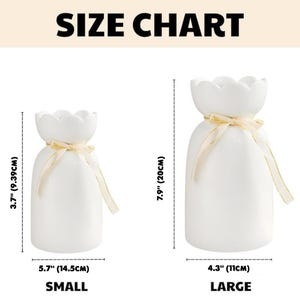 May include: White ceramic vases with a scalloped top and a ribbon tied around the neck. The small vase is 3.7 inches (9.39cm) tall and 5.7 inches (14.5cm) wide. The large vase is 7.9 inches (20cm) tall and 4.3 inches (11cm) wide. The text "SIZE CHART" is at the top.