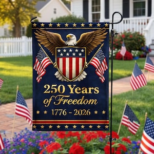 May include: A navy blue garden flag featuring a patriotic design with an eagle, American flags, and a shield. The text reads "250 Years of Freedom 1776-2026" in gold lettering. The flag is displayed on a black metal stand.