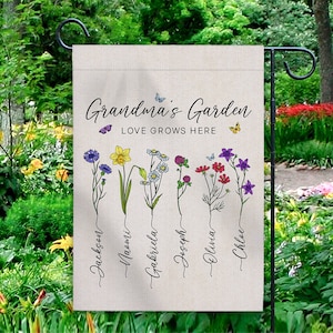 May include: A garden flag with the text "Grandma's Garden, Love Grows Here".  The flag features five different flowers with the names Jackson, Naomi, Gabriella, Joseph, Olivia, and Chloe written below each flower.